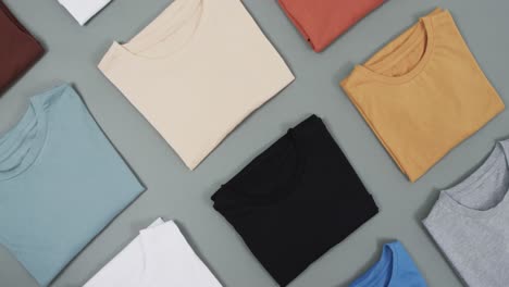 Video-of-flat-lay-of-t-shirts-with-copy-space-on-grey-background