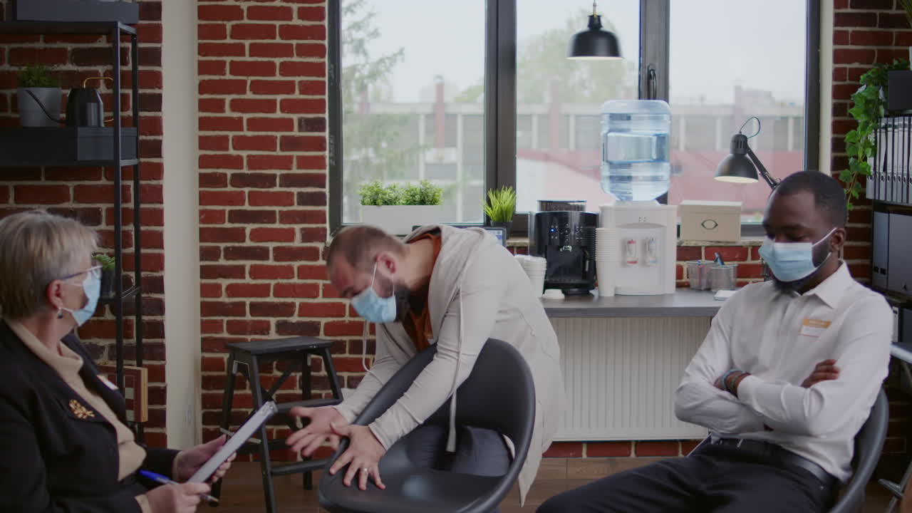 Man with anger management issues having desperate reaction at aa group meeting with therapist