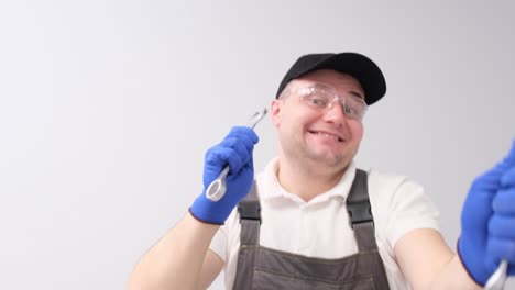 Male Auto Mechanic in Uniform Dancing Holding Car Repair Wrenches Happy and Smiling at Camera. Male auto mechanic in uniform dancing holding car repair wrenches, happy and smiling at camera. A place to advertise car repair. video