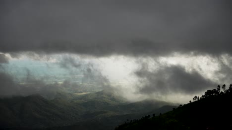 dramatic cloudscape enveloping a forested valley creates a moody, atmospheric landscape, highlighting nature's beauty and tranquility