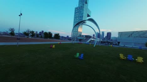 glass facade of port of montreal tower tourist attraction in montreal, canada, fpv shot