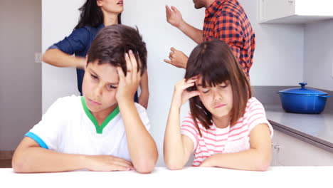 couple arguing in front of children