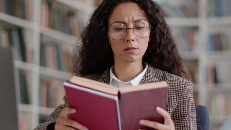 Woman Studying a Book in a Library