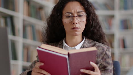 woman studying a book in a library
