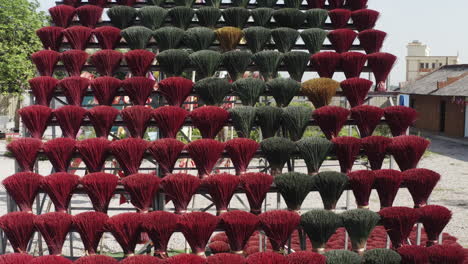 rows of colorful incense sticks drying in the sun at quảng phú cầu incense village