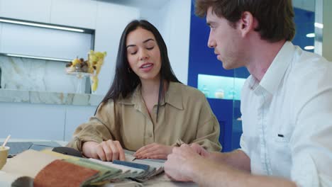 People discussing fabric samples for interior design