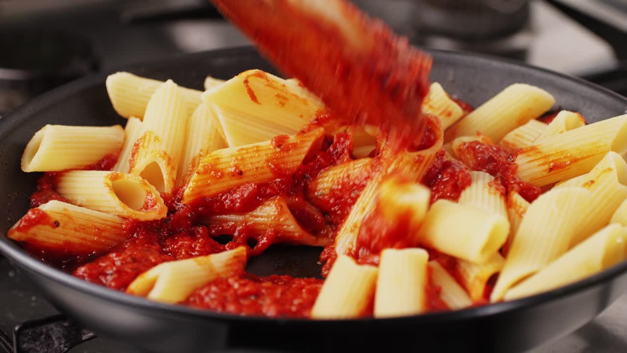 Cooking Penne Pasta with Tomato Sauce