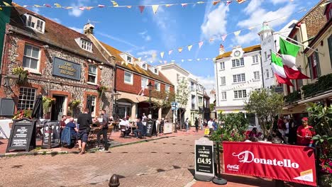 people walking and cars on a sunny day