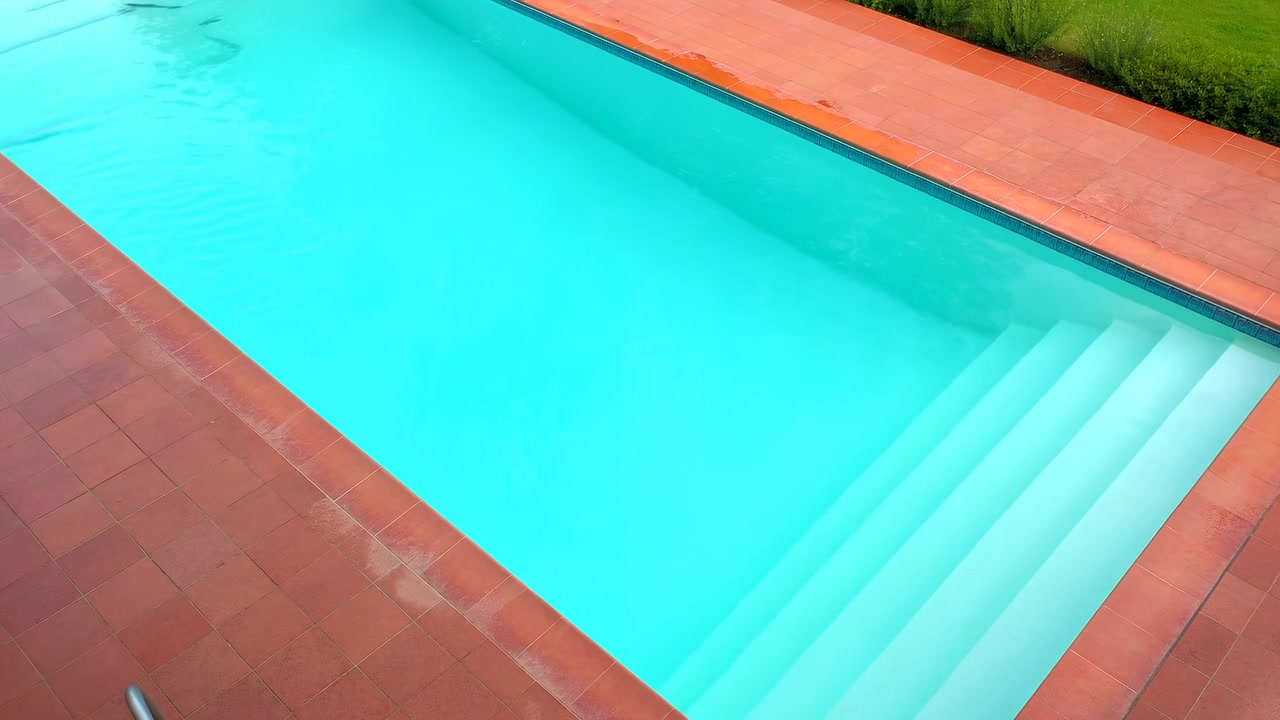 Swimming pool no action observed static scene, in outdoor residential area with grass and wooden deck, with swimming pool, wooden deck, grass, with concrete, wood, grass texture, clear detail.