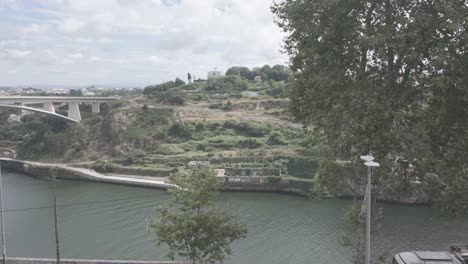 A scenic view of the Ponte do Infante bridge crossing the Douro River in Porto on a cloudy day