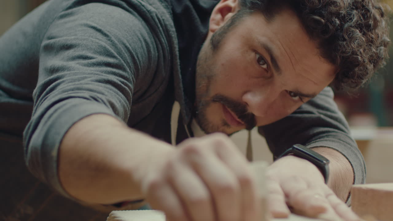 Craftsman Polishing Edges of Wooden Tray with Sandpaper