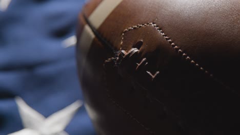 close up studio shot of american football on stars and stripes flag 3