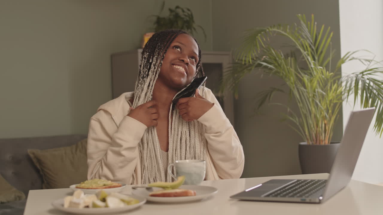 African American Woman Chatting on Phone during Breakfast
