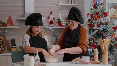 grandmother showing to grandchild how to prepare traditional cookies dessert