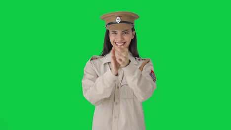 Happy-Indian-female-police-officer-clapping-and-appreciating-Green-screen