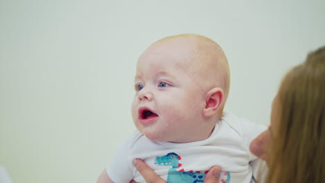 Baby visiting doctor. Woman with little baby visiting pediatrician in clinic