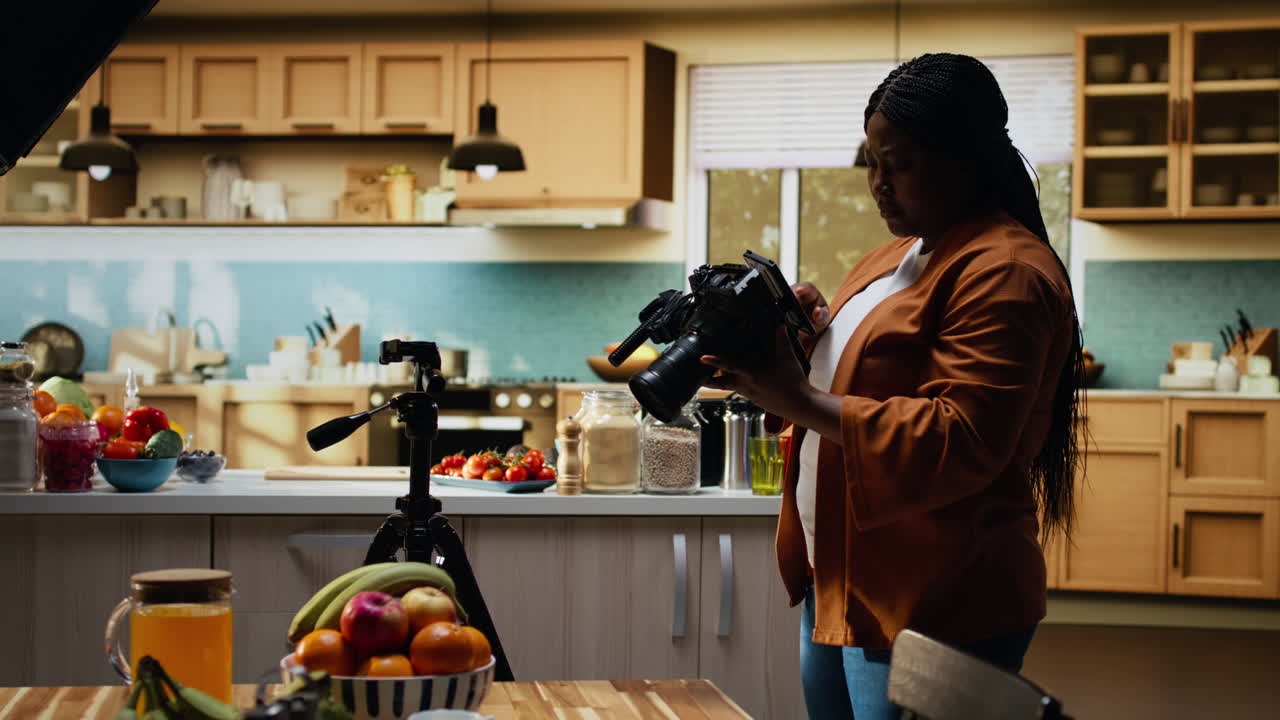 Vlogger afroamericana che effettua preparativi per le riprese nella cucina di casa