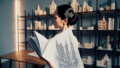 architect reviewing building designs and models in her studio