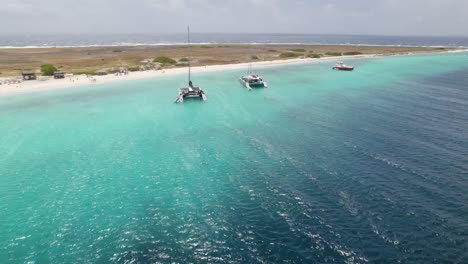 aerial fast orbit over the sandy beach of the klein curacao island