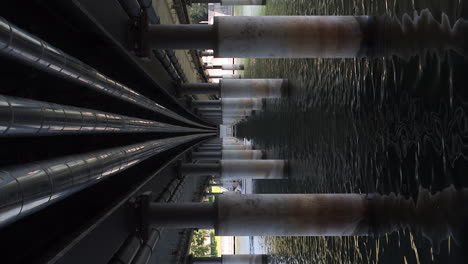 vertical view of speedboat passing under the chelles allee bridge in lindau, bodensee, germany