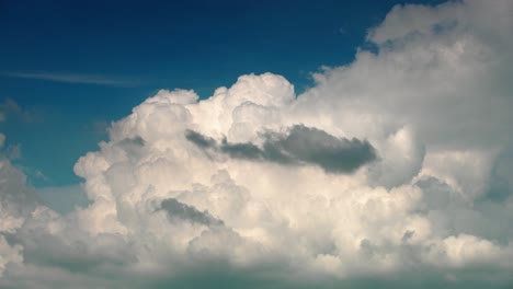 dramatic dark gray rain filled clouds form and rise in sky