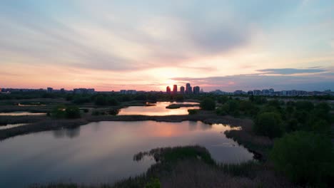 aerial view over delta vacaresti at sunset, with birds flying, sunset colors, orange, red, yellow, bucharest, romania