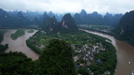 Aerial-descendant-approaching-pagoda-and-antenna-located-on-top-of-Laozhai-Hill,-China