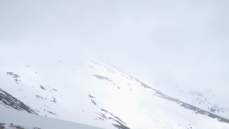 scenic panorama of snow covered slopes and low clouds on parang mountains in romania in winter