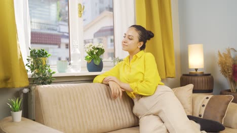 the young woman looking out the window.