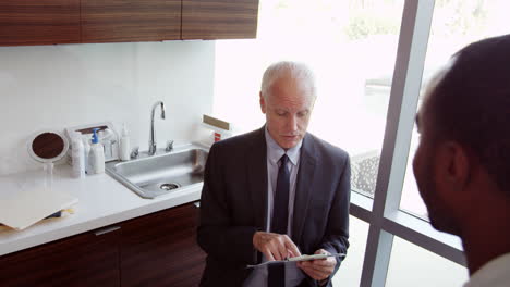 Doctor-Meets-With-Male-Patient-In-Exam-Room-Shot-On-R3D