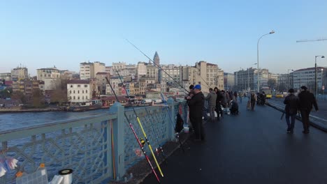 people fishing on a bridge in istanbul, turkey