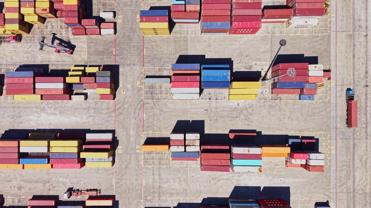 Cargo containers stacked at a shipping yard in the daytime