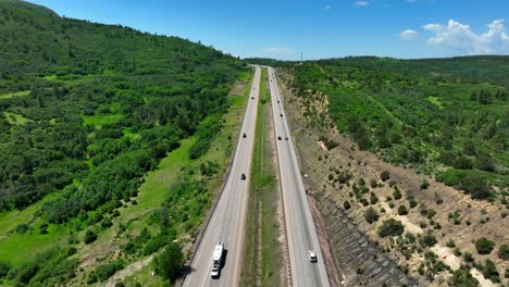 Aerial-rising-shot-of-scenic-highway-in-Rocky-Mountains-in-summer