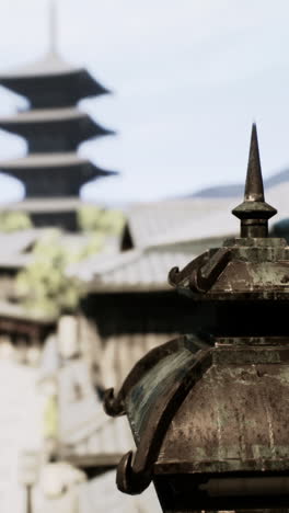 a traditional japanese stone lantern in front of a pagoda