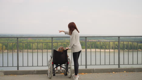 woman shows large park to daughter with spinal cord injury