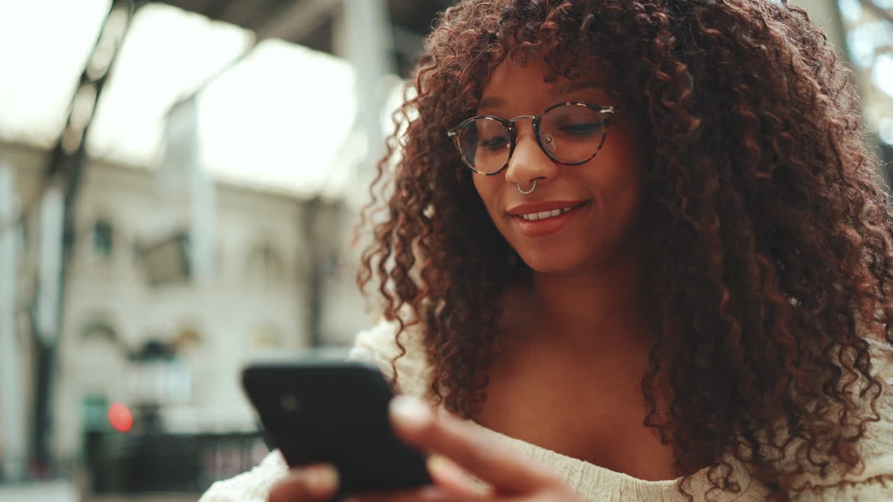 Woman with curly hair using smartphone