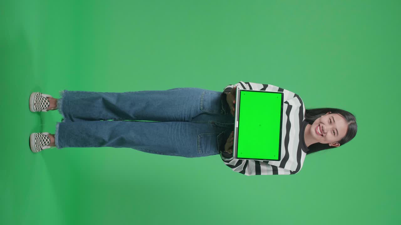 mujer sosteniendo una laptop con pantalla verde