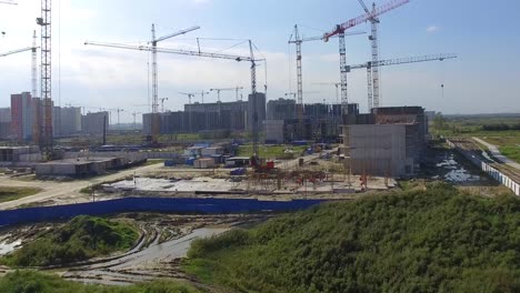 construction site with multiple cranes and buildings under development