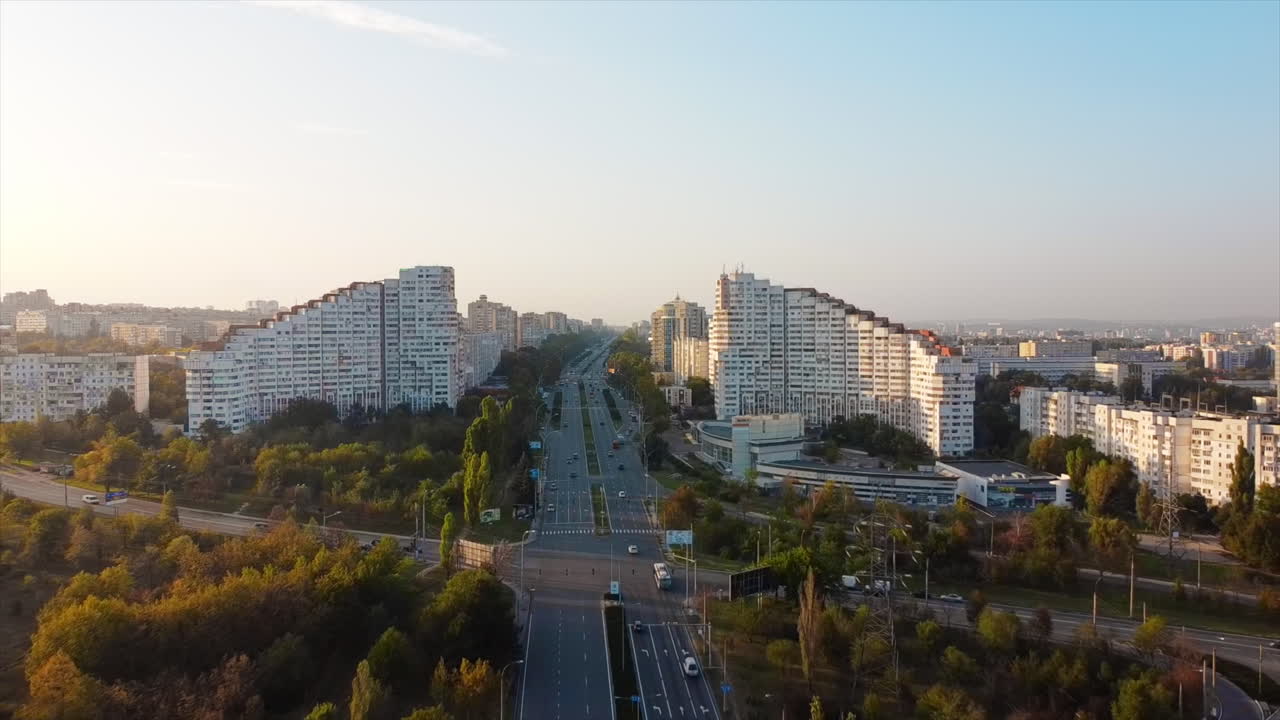 Aerial drone view of Chisinau at sunset, Moldova. View of the City Gates with multiple buildings and yellowed trees around