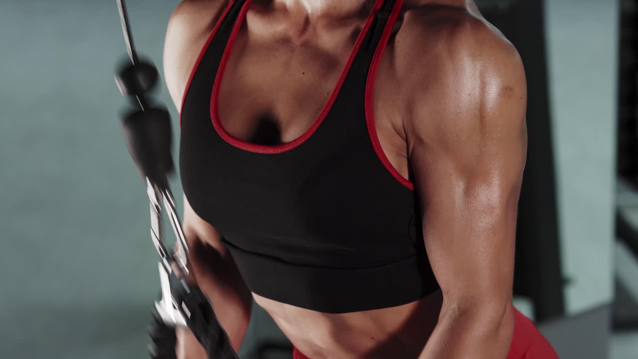 Frau trainiert am Kabelzug im Fitnessstudio