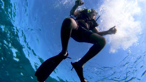 a tourist enjoying snorkeling and diving in ocean cheering up with thumbs up | cheering underwater during diving and snorkeling, enjoying experience