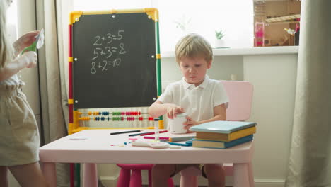 little boy examines tabletop humidifiers sitting in playroom