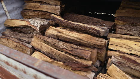 Piles of firewood stacked high in shed, 4K
