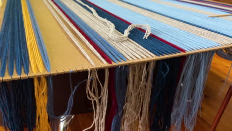 Craftsman-weaving-new-blanket-with-colorful-thread,-static-view