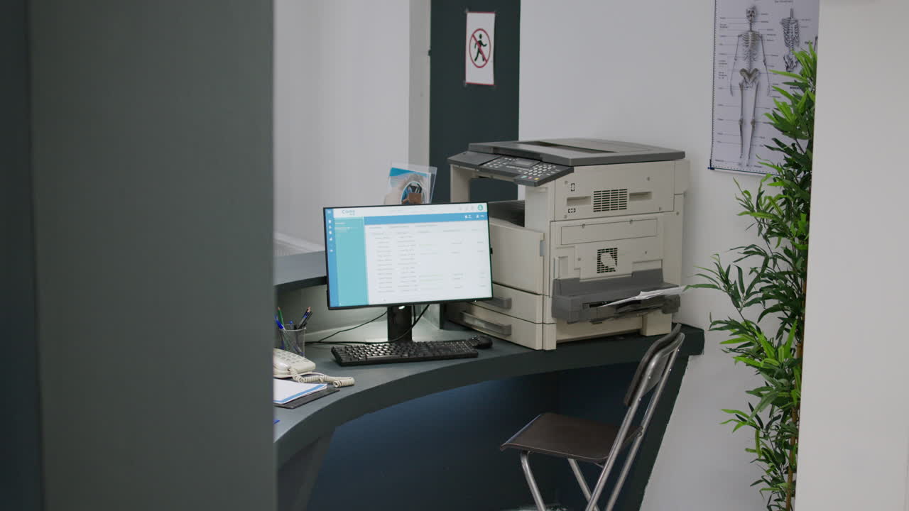 Office with computer, printer, and desk