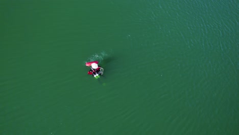 Top-down-shot-overhead-of-a-diver-on-the-surface-with-bubbles-rising-to-the-surface