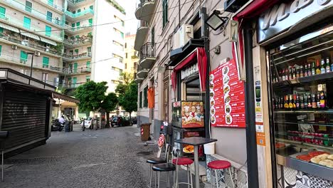 a bustling food shop on a naples street