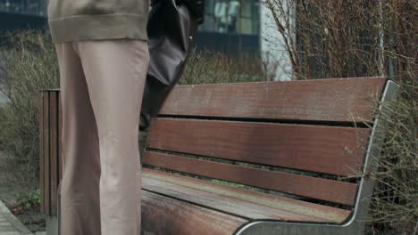 man sitting on a bench with a backpack