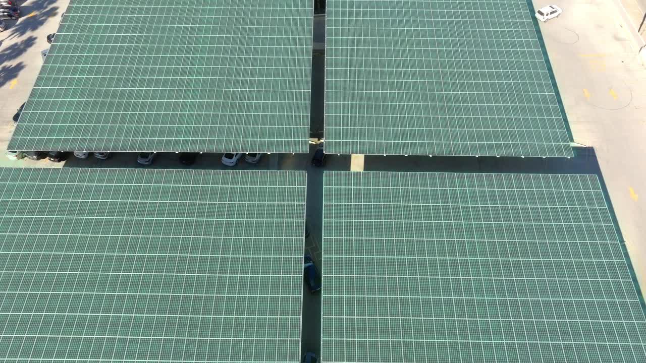 Sunlight activating carport solar panels at a parking lot - Aerial 3D overlay