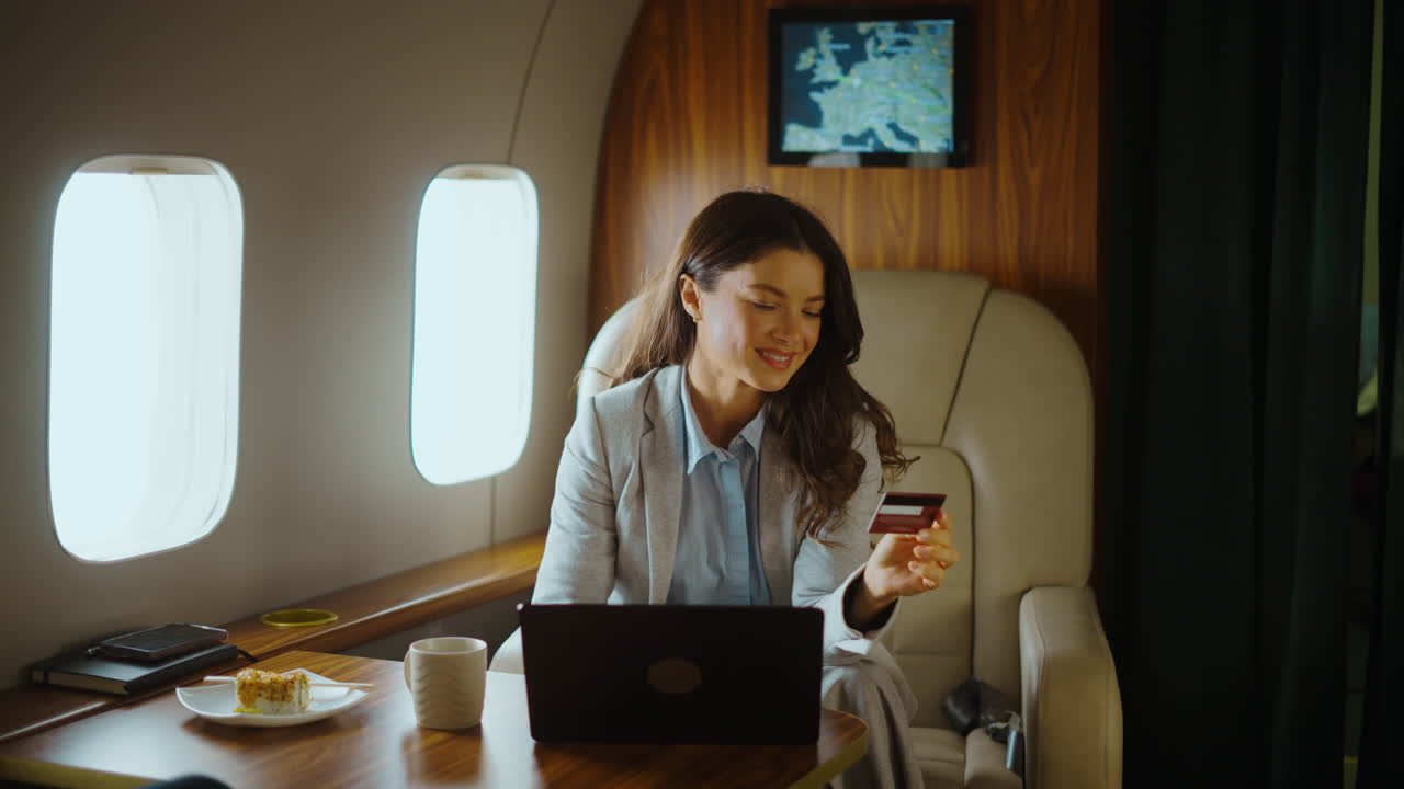Woman in Private Jet Holding Credit Card